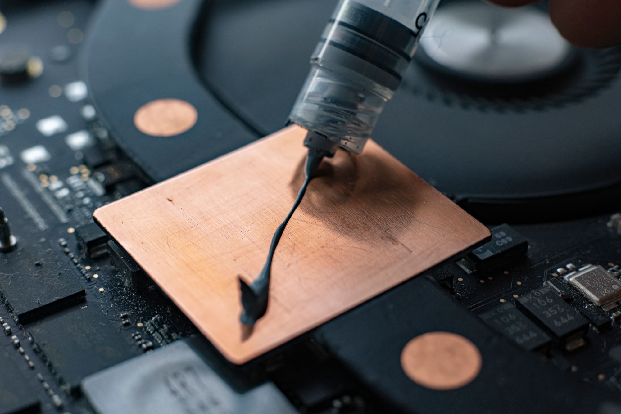 a applying the thermal grease to the gpu chip for better heat management, macro view